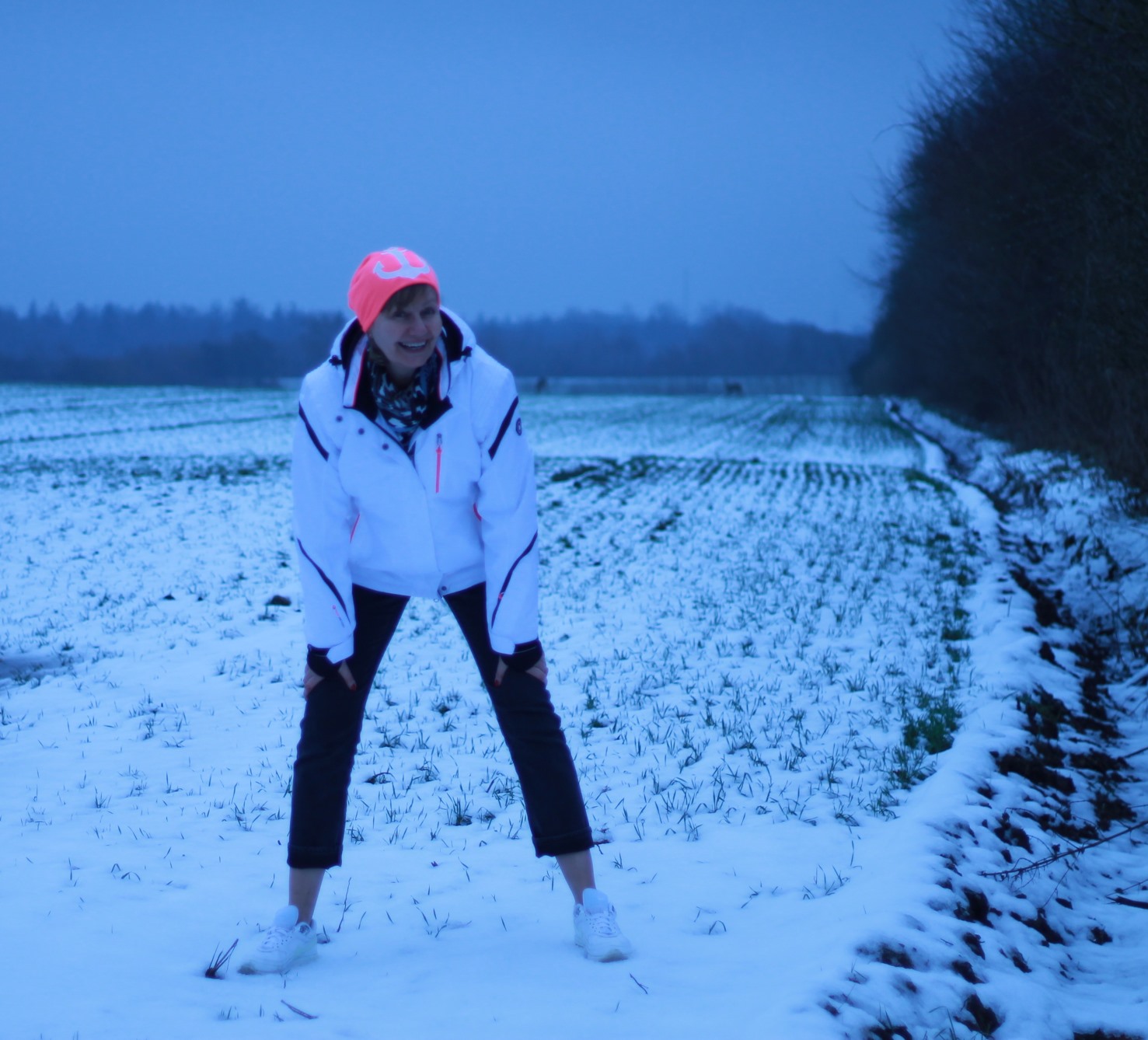 Feld Schnee weisse Jacke Muetze pink mit anker rehe in der ferne